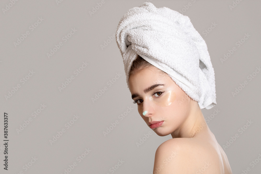 portrait of a beautiful woman on a gray background. Home procedures for body and face care. copycpase portrait of a beautiful woman on a gray background. Home procedures for body and face care. copycpase