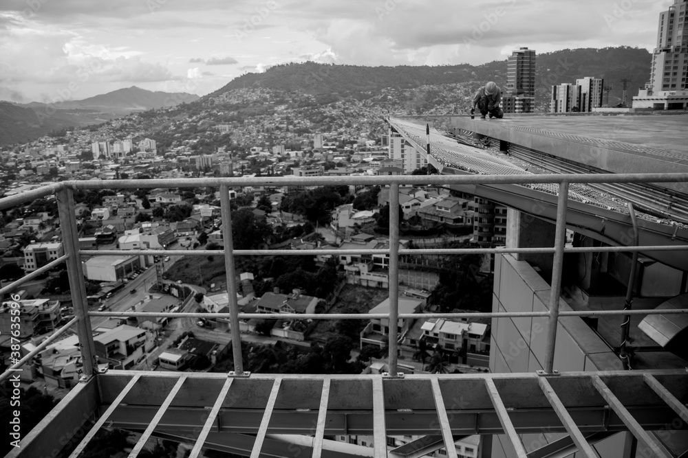Fototapeta premium worker painting details on helipad with safety equipment