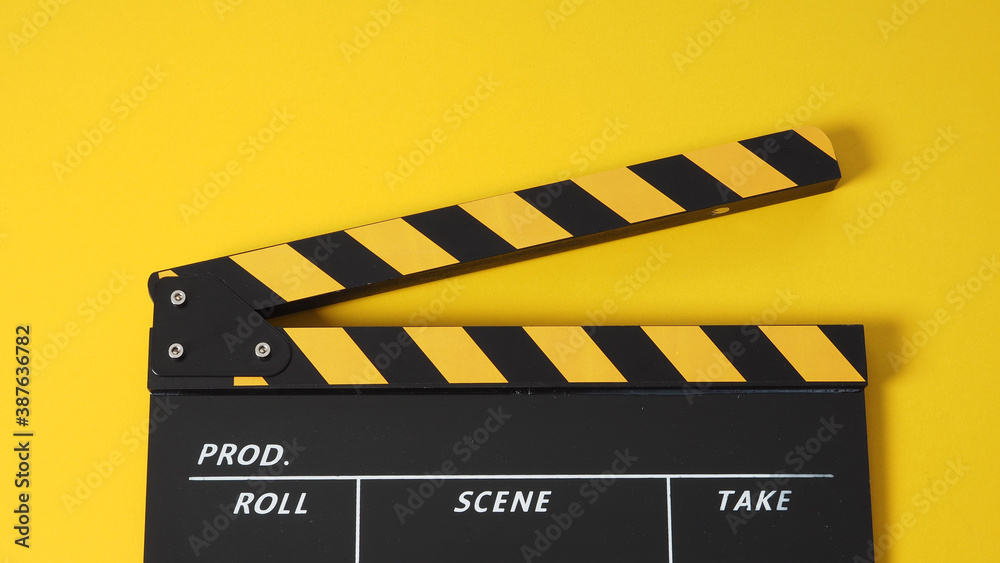 Clapper board or movie slate. it use in video production and cinema industry on yellow background.