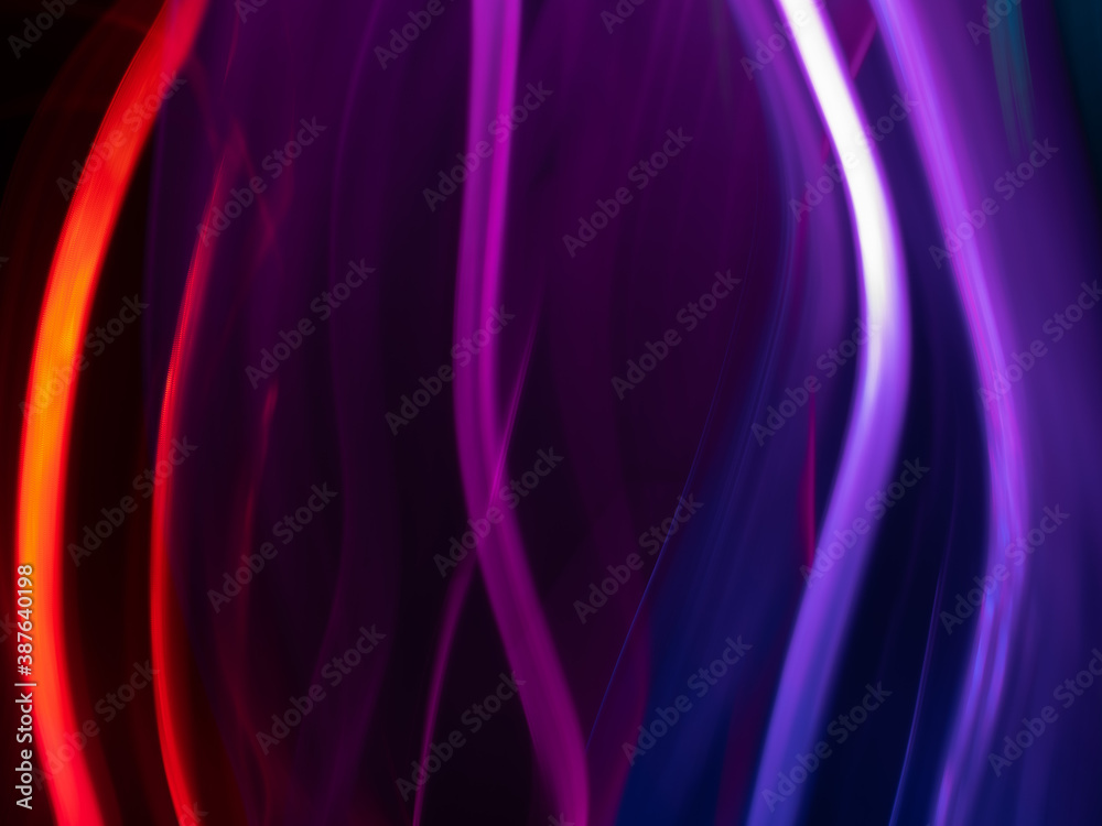 Obraz premium light painting photography, waves of vibrant color against a black background. Long exposure photo of vibrant fairy lights in abstract