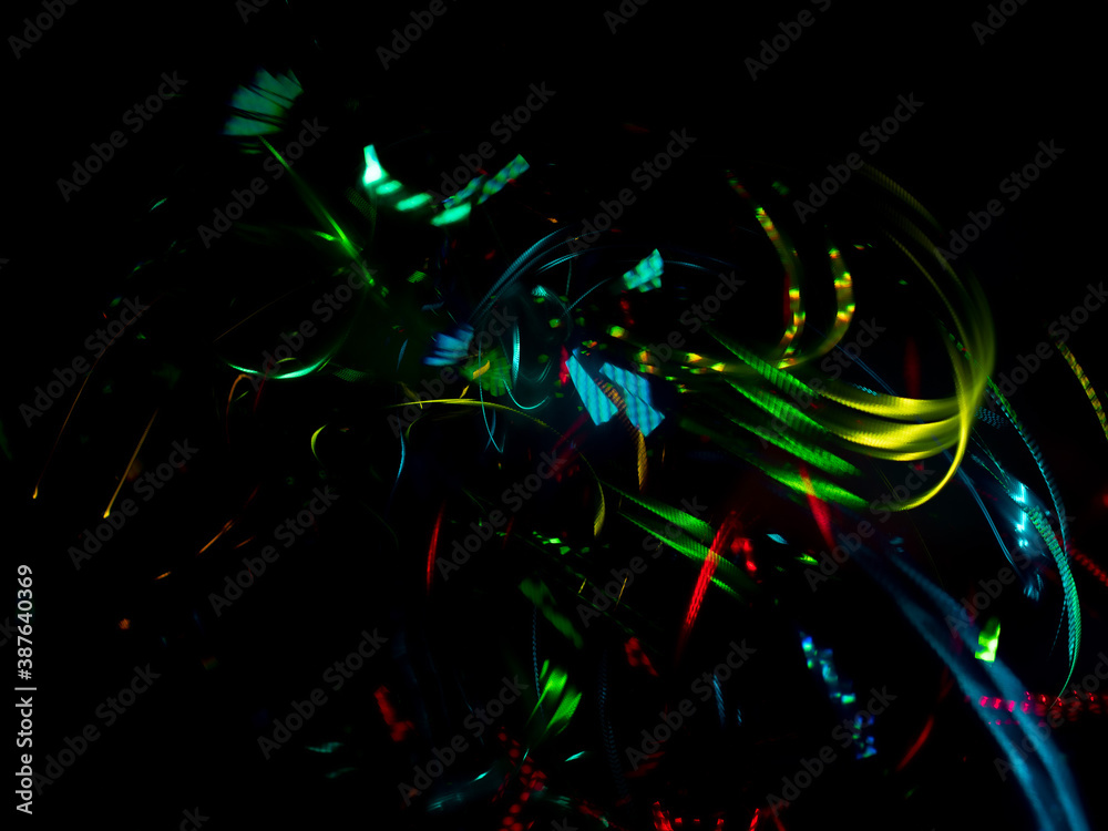 light painting photography, waves of vibrant color against a black background. Long exposure photo of vibrant fairy lights in abstract