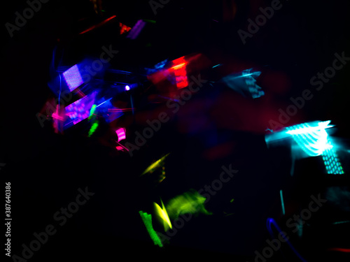 light painting photography, waves of vibrant color against a black background. Long exposure photo of vibrant fairy lights in abstract