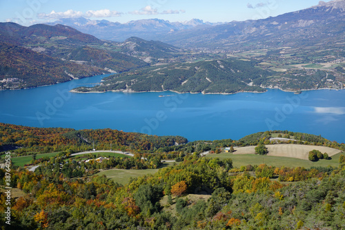 bird eye view of Serre Ponçon lake, France in the fall on a glorious blue day