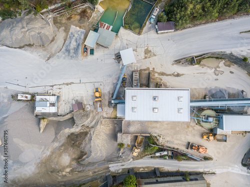 Canvas Print Aerial view of quarrying pit with mining factory from above.