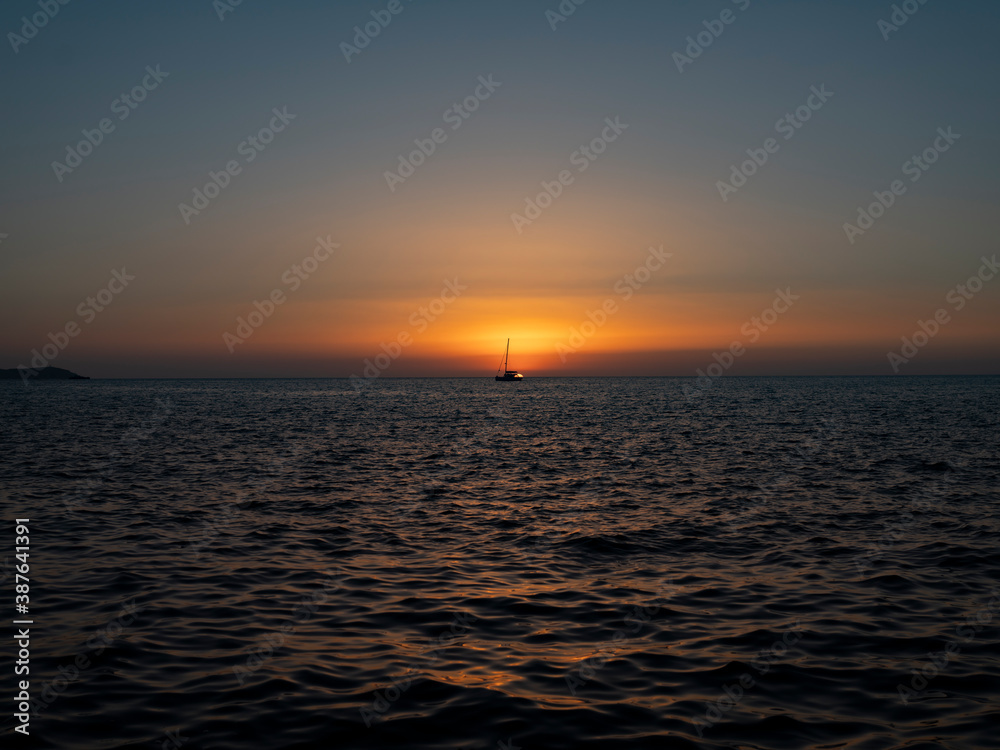 ship crosses the sea in the sunset