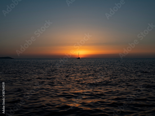 Fototapeta Naklejka Na Ścianę i Meble -  ship crosses the sea in the sunset