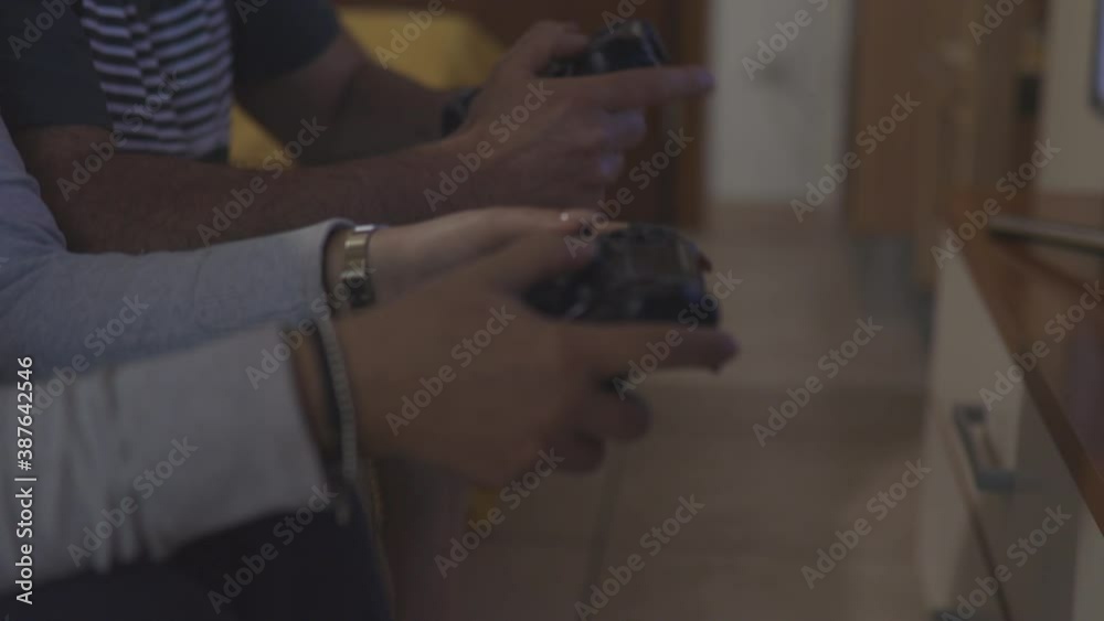 Video game match. Boyfriend and girlfriend plays a soccer game. Closeup shot Video game match. Boyfriend and girlfriend plays a soccer game. Closeup shot