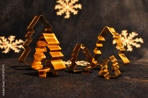 A Christmas decoration gift design with pine tree objects with white snow flakes dark blue blanket in the background