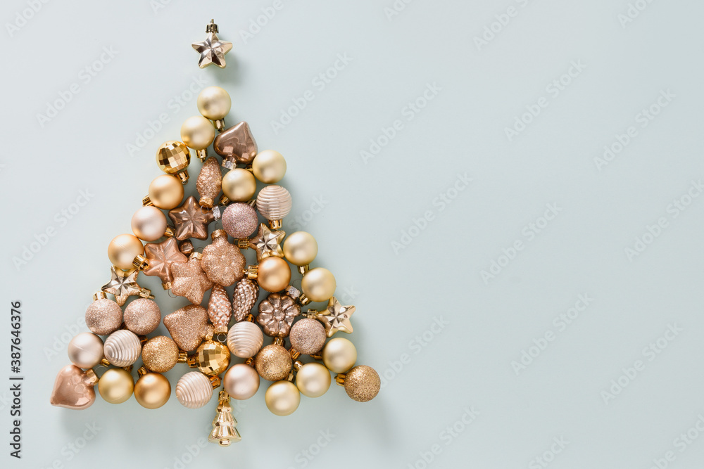 Christmas greeting card golden shiny baubles in shape of tree on blue. Top view. Creative Xmas tree. Greeting card. Christmas greeting card golden shiny baubles in shape of tree on blue. Top view. Creative Xmas tree. Greeting card.