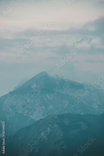 A moutain top in dusk light on a foggy morning day in Triglav ntional park in Slovenia photo