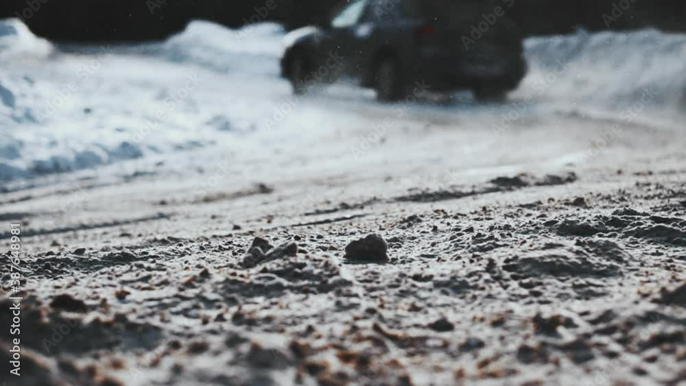 Close up of car wheels riding and drifting past away on snowy surface. Polar expedition or sport extreme racing. Background concept. Burnout acceleration. Close up of car wheels riding and drifting past away on snowy surface. Polar expedition or sport extreme racing. Background concept. Burnout acceleration.