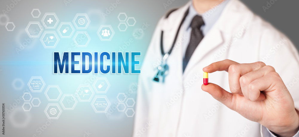 Close-up of a doctor giving you a pill with MEDICINE inscription, medical concept Close-up of a doctor giving you a pill with MEDICINE inscription, medical concept