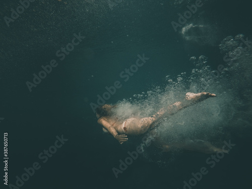European young woman diving and swimming underwater in Croatia in mediterranean sea © Nia