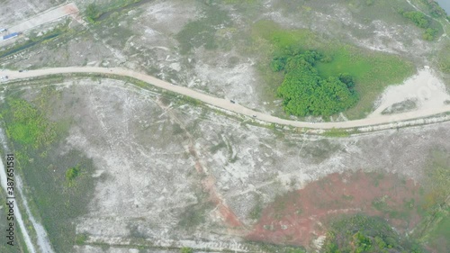 Drone view flying above sandy beach with trees. Melaka Beach, Malaysia.  photo