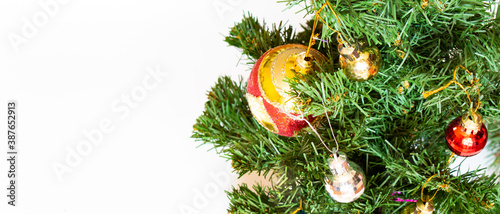 Decorated Christmas tree on white background. Golden toy ball and brown cone. Happy New Year 2021.Christmas mood. Atmosphere