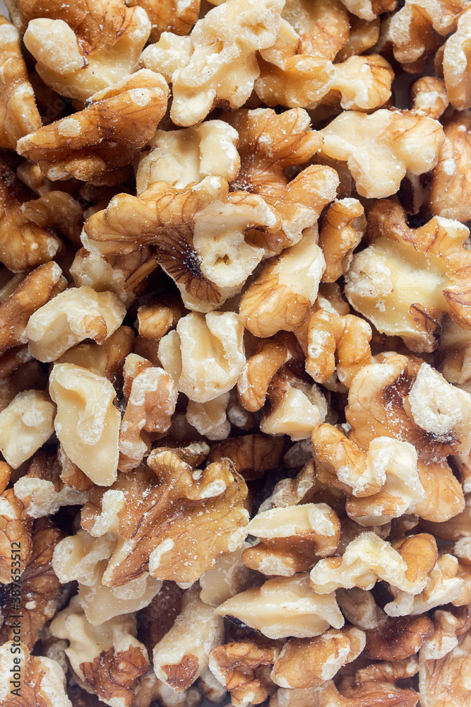 A pile of peeled walnuts piled up. Preparation of healthy desserts. A pile of peeled walnuts piled up. Preparation of healthy desserts.