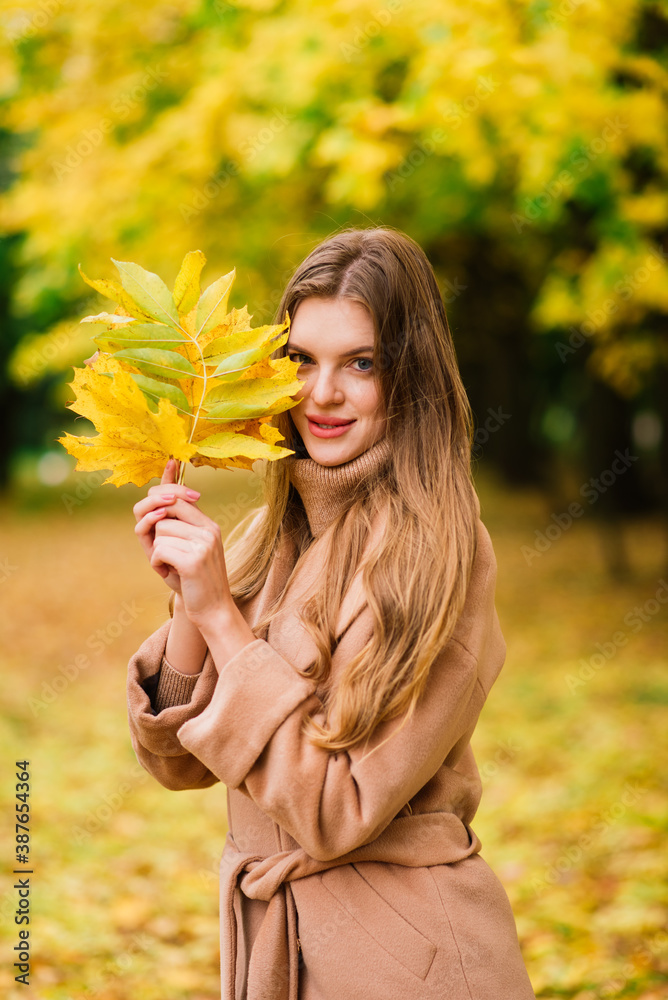 Beautiful woman spending time in park during autumn season Beautiful woman spending time in park during autumn season