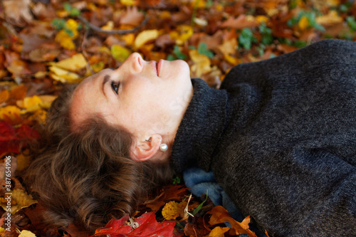 Beautiful lying on Colorful Autumn Leaves