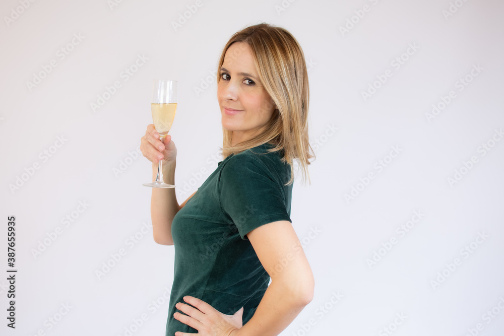 Young celebrating woman black dress . Beautiful model portrait isolated over studio background hold wine glass. Young celebrating woman black dress . Beautiful model portrait isolated over studio background hold wine glass.