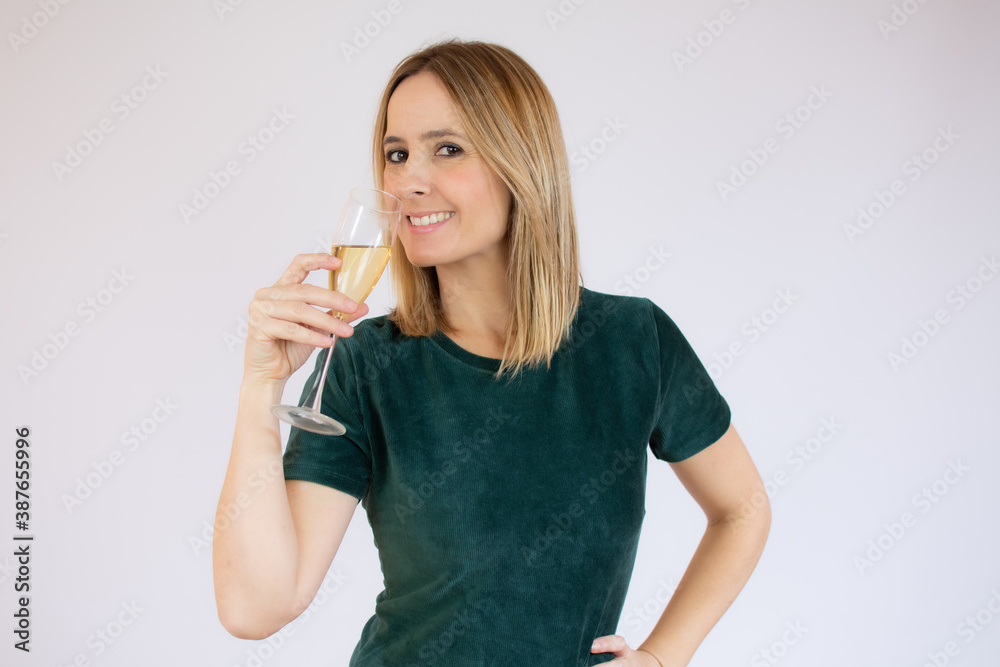 Young celebrating woman black dress . Beautiful model portrait isolated over studio background hold wine glass. Young celebrating woman black dress . Beautiful model portrait isolated over studio background hold wine glass.