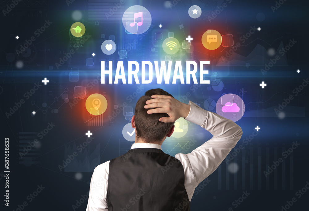 Rear view of a businessman with HARDWARE inscription, modern technology concept Rear view of a businessman with HARDWARE inscription, modern technology concept