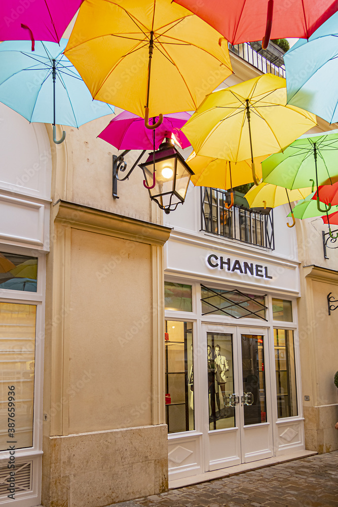 View of Paris Royal Village with an "umbrella sky". Paris Royal Village  passage located near Madeleine Church is very charming and filled with  luxury shops. PARIS, FRANCE. May 21, 2019. Photos | Adobe Stock