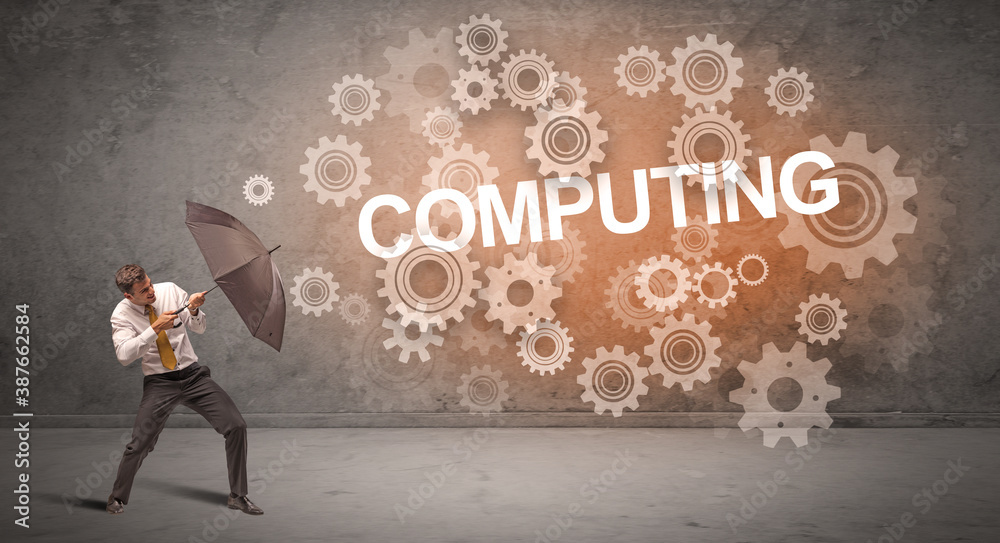 Businessman defending with umbrella from COMPUTING inscription, technology concept Businessman defending with umbrella from COMPUTING inscription, technology concept