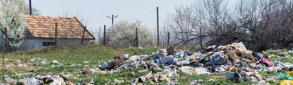 Plastic bags and bottles in a landfill. Unauthorized release of garbage, pollution of nature. The concept of environmental disaster. Plastic bags and bottles in a landfill. Unauthorized release of garbage, pollution of nature. The concept of environmental disaster.