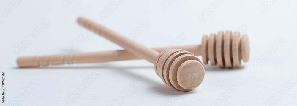 Wooden sticks for honey on a white background Wooden sticks for honey on a white background