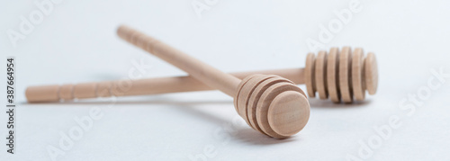 Wooden sticks for honey on a white background