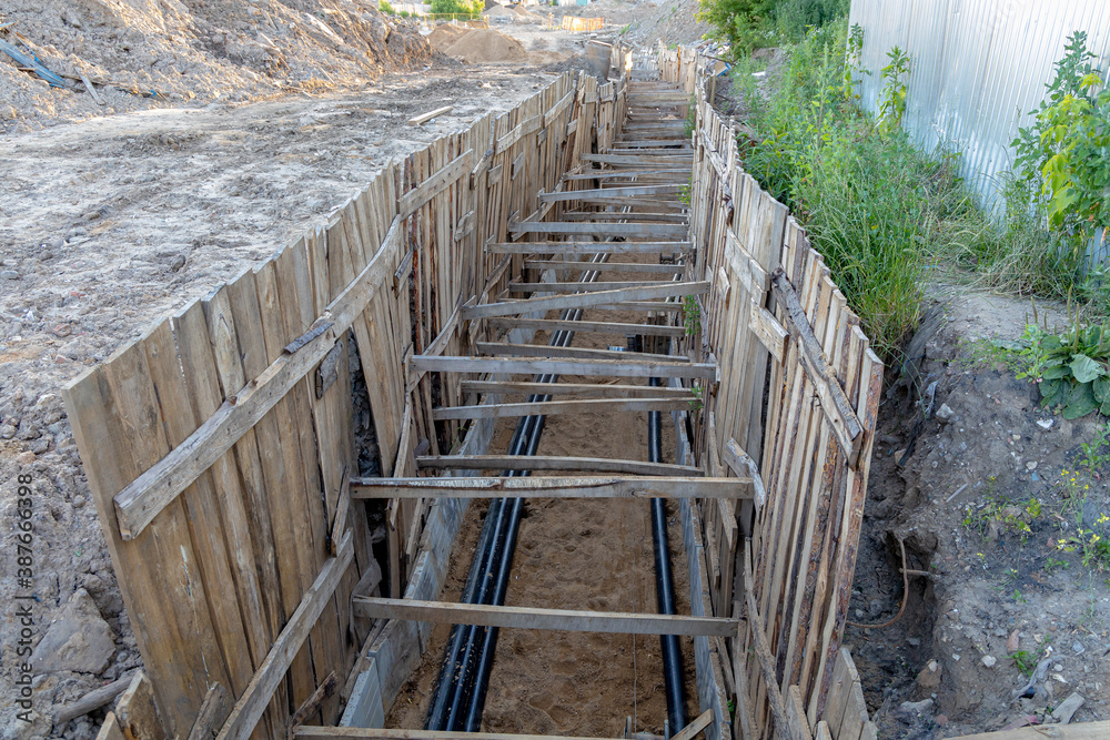 Trench with electrical cables. Laying the cable underground