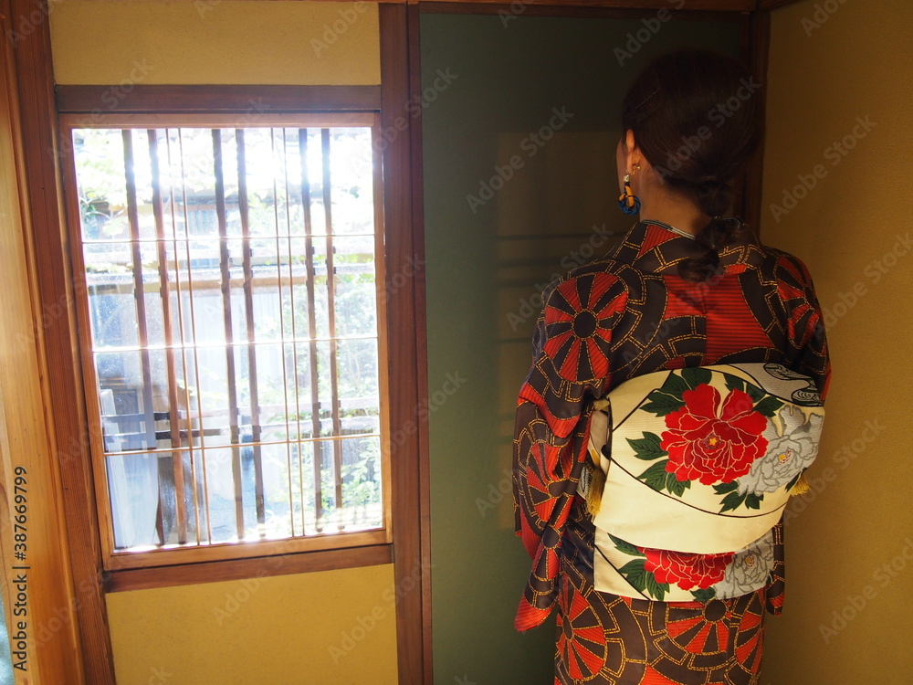 An Asian woman wearing a traditional Japanese kimono at Japanese-style restaurant, Kyoto, Japan An Asian woman wearing a traditional Japanese kimono at Japanese-style restaurant, Kyoto, Japan