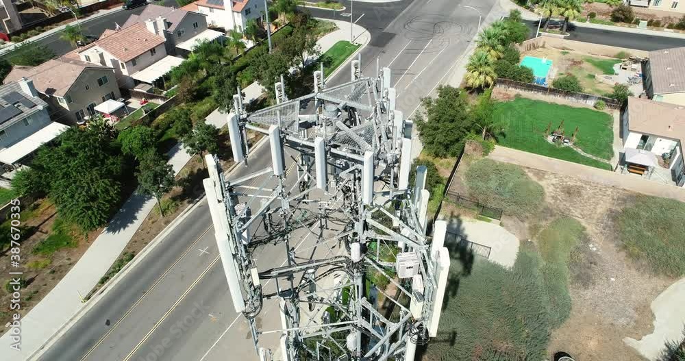 4K Close-up Aerial of Cellular Wireless Mobile Data Tower with Neighborhood Surrounding.