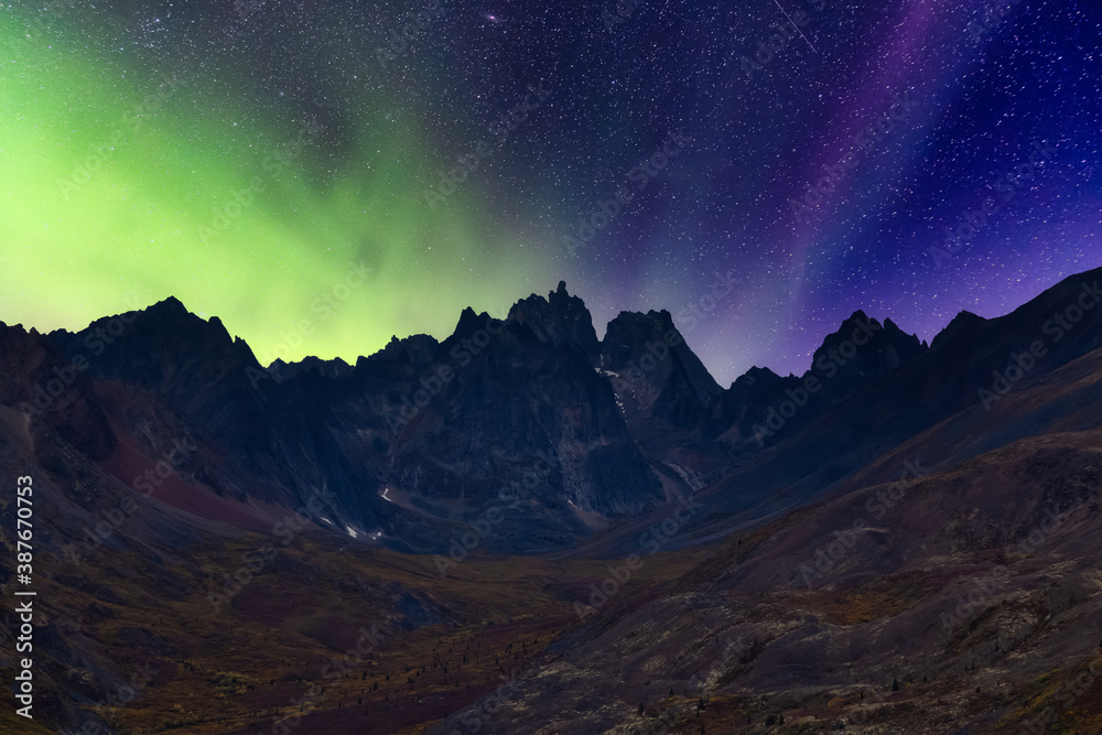 Beautiful Aerial View of Scenic Mountain Landscape in Canadian Nature. Night Star Sky with Northern Lights. Taken near Grizzly Lake in Tombstone Territorial Park, Yukon, Canada.