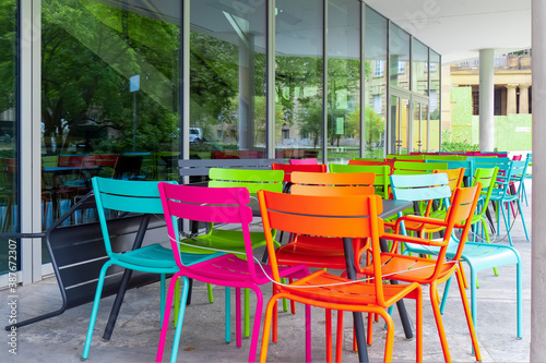 Fototapeta Naklejka Na Ścianę i Meble -  Deserted chairs and tables in front of a café which is closed due to a coronavirus