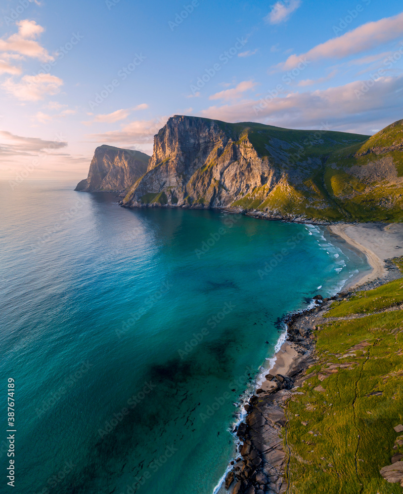 Aerial view of Lofoten islands, Northern Norway, Kvalvika beach, during sunset.