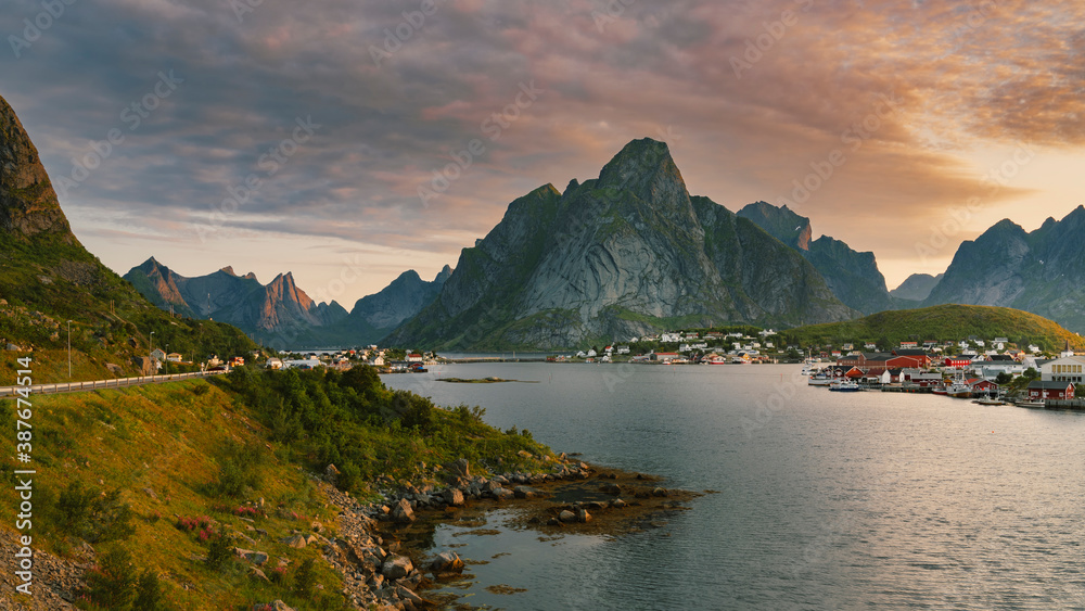 Beautiful colourful sunrise over Reine town and mountains in background during sunrise in Lofoten, Norway.