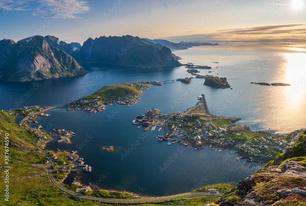 Aerial view of Reine town and mountains in background during sunrise in Lofoten, Norway. Captured from above.