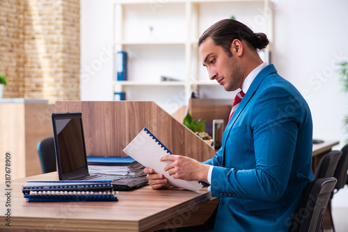 Young male employee working in the office