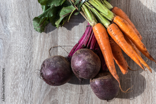 fresh organic carrots and beets on wooden table in Brazil