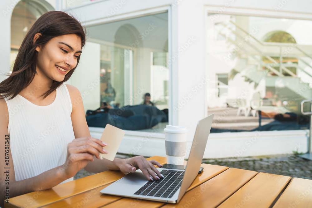 Young woman using laptop to shop online. Young woman using laptop to shop online.
