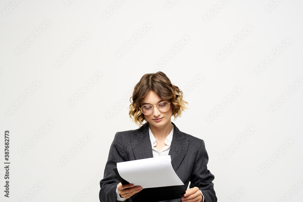 Woman in business suit finances work documents glasses hairstyle Woman in business suit finances work documents glasses hairstyle