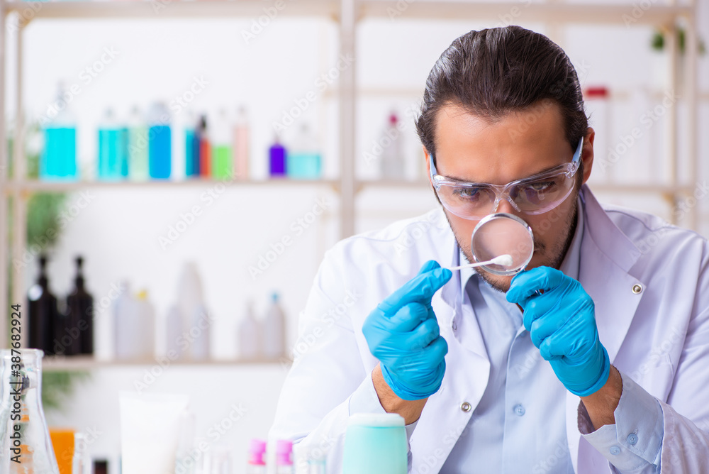Young male chemist working in the lab Young male chemist working in the lab