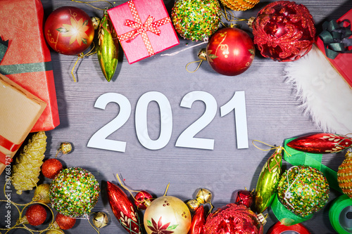 Christmas ornaments with 2021 numbers on table © Creativa Images