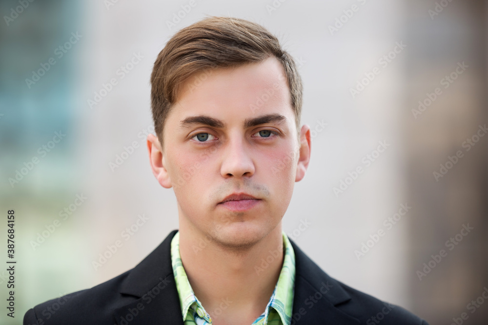 Young handsome man in black blazer walking on street Young handsome man in black blazer walking on street