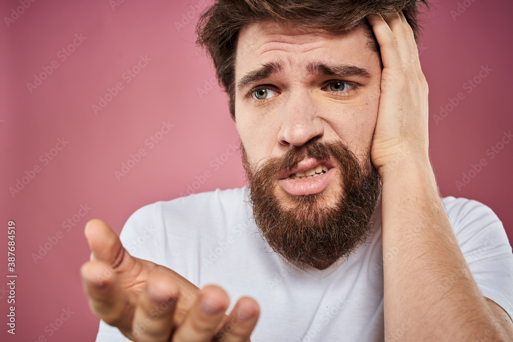 bearded man in white t-shirt emotions displeased facial expression studio pink background bearded man in white t-shirt emotions displeased facial expression studio pink background