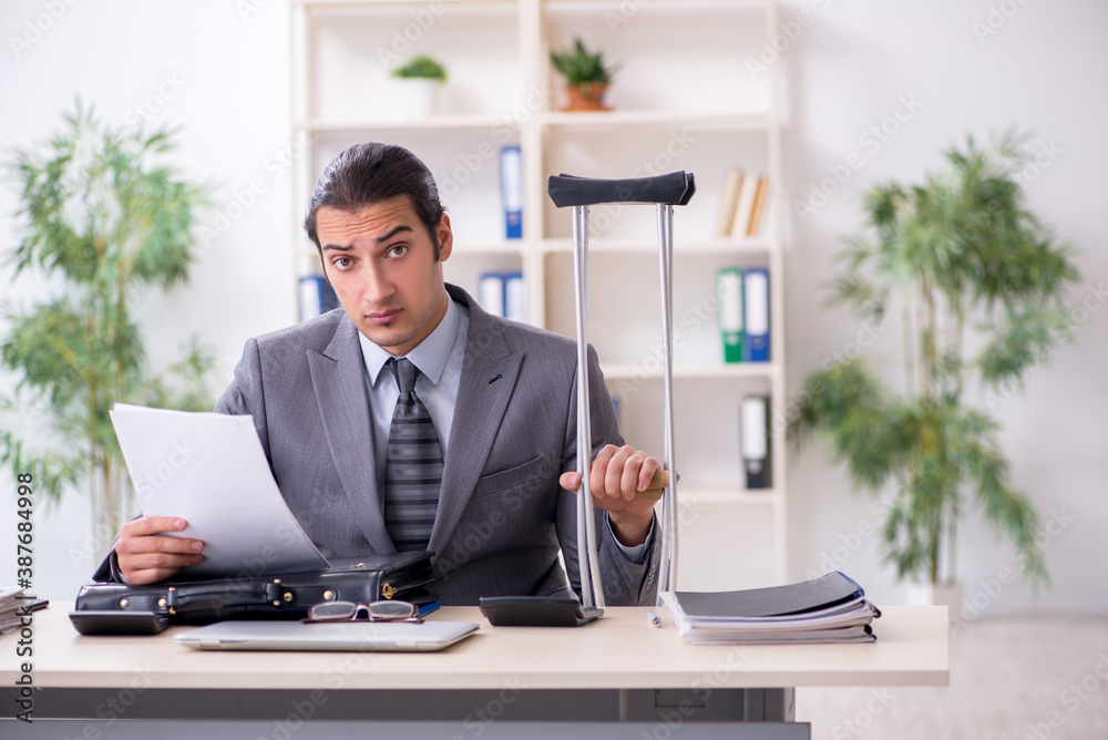 Young male employee after accident at workplace Young male employee after accident at workplace