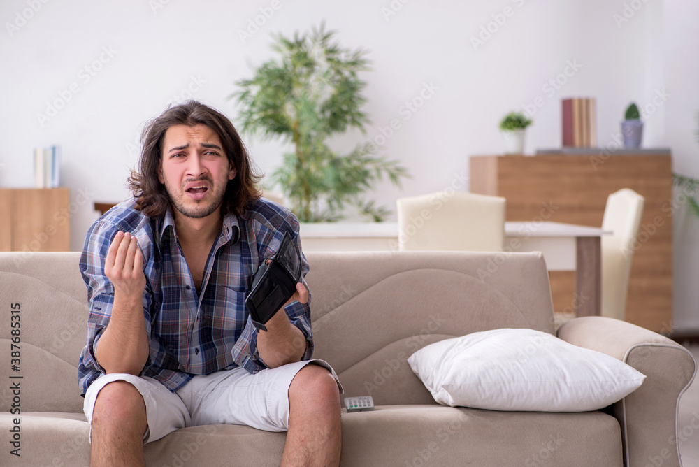 Young male student in poverty concept Young male student in poverty concept