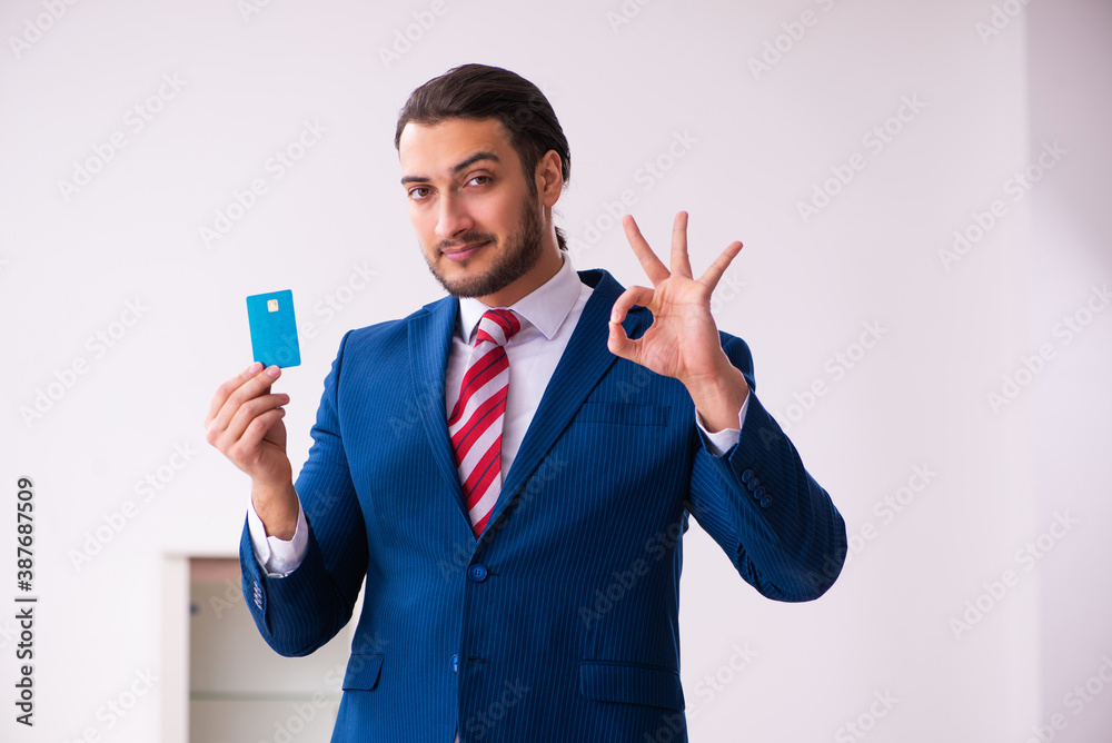 Handsome male realtor working indoors Handsome male realtor working indoors