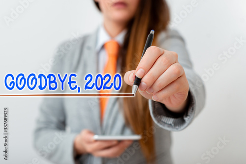 Handwriting text writing Goodbye 2020. Conceptual photo New Year Eve Milestone Last Month Celebration Transition Model displaying different shots of holding pen ready for promotional use photo